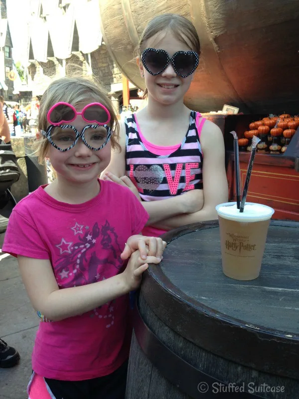 Drinking a ButterBeer (no alcohol) at Universal Orlando Wizarding World of Harry Potter | StuffedSuitcase.com