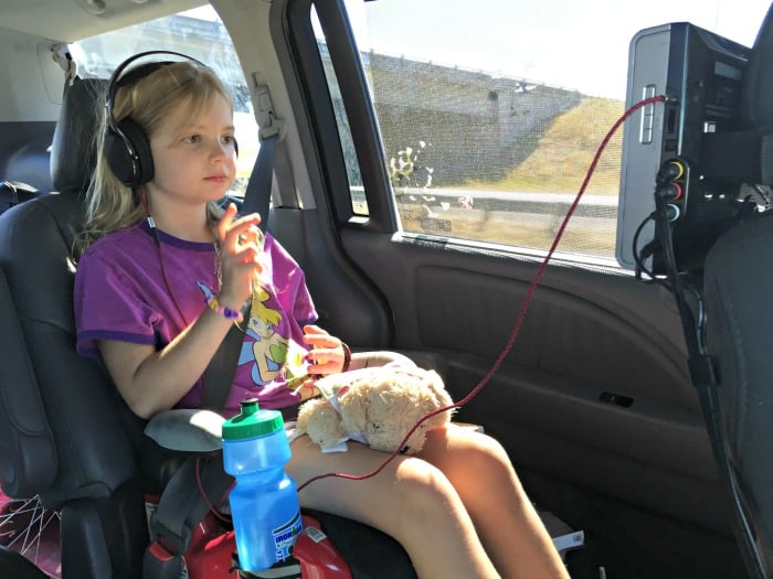 kid watching dvd movie on road trip