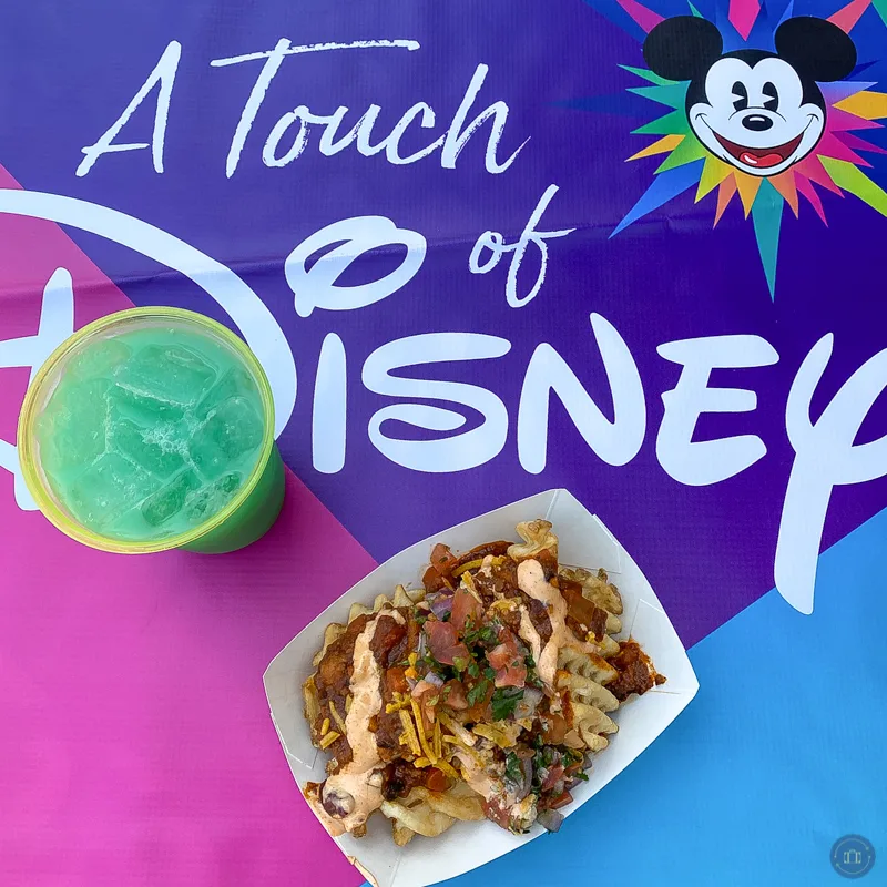 impossible chili fries and blue angeleno cocktail on touch of disney table