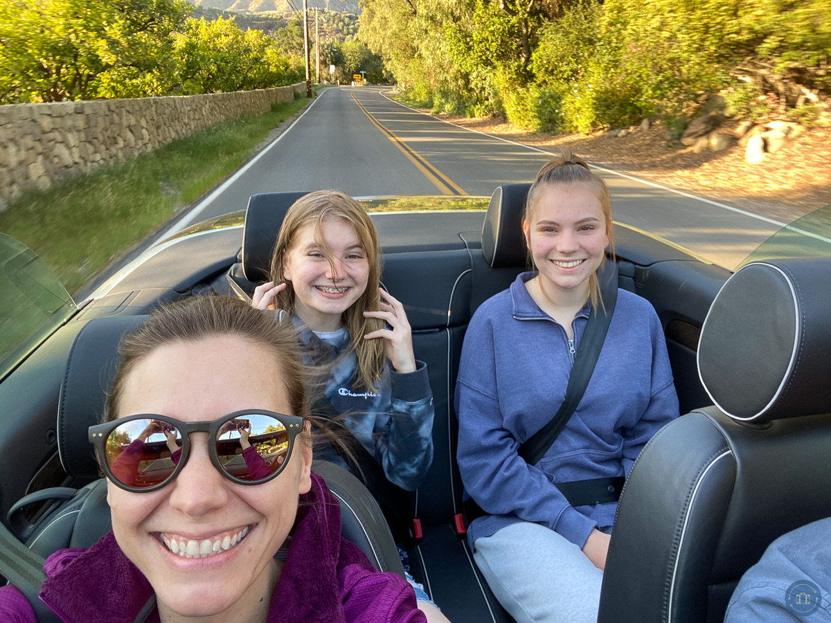 family in convertible car