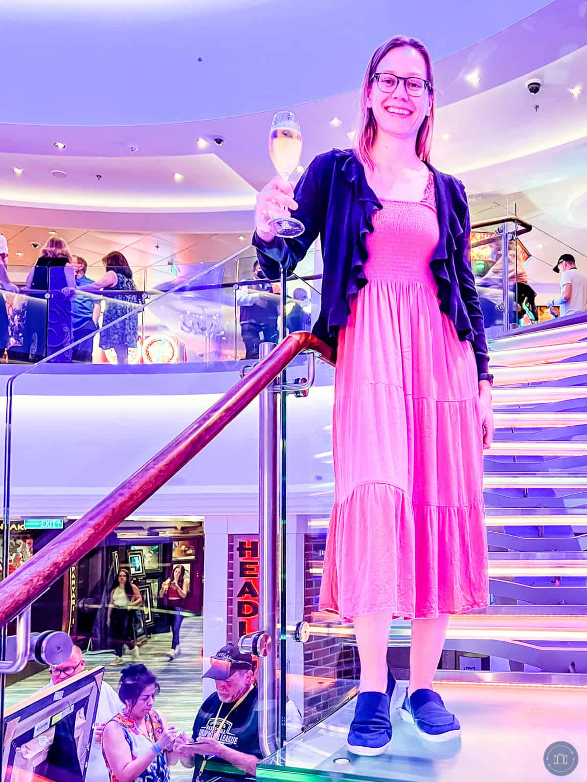 woman wearing dress and cardigan on cruise ship stairway