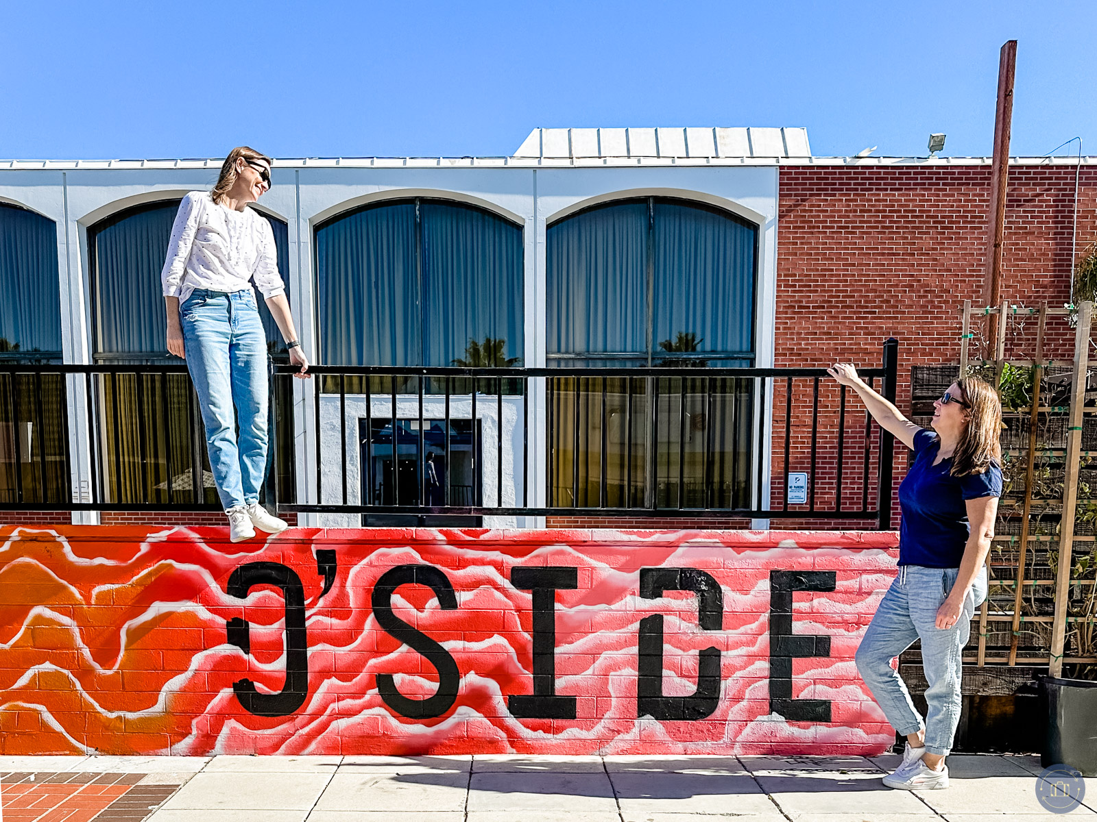 two women posing by oside street mural in oceanside ca