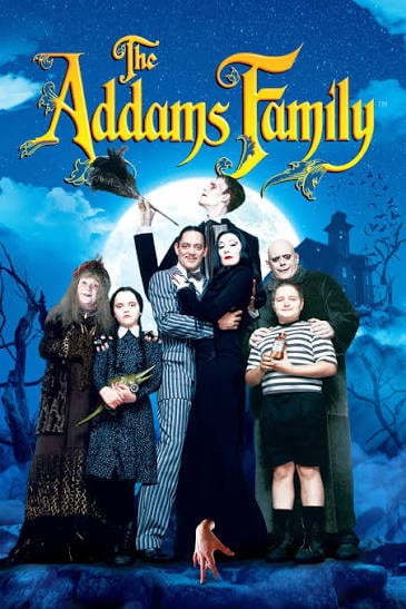 aul Julia and Anjelica Huston as Gomez and Morticia standing with the live-action cast under a bright full moon for the 1991 film The Addams Family