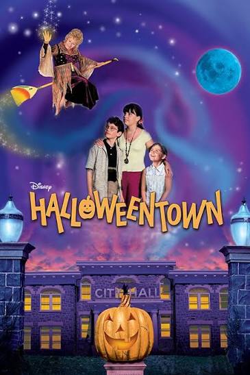 Disney Halloweentown movie poster featuring Marnie, her siblings, Aggie Cromwell on a broomstick, and the iconic giant pumpkin in front of City Hall