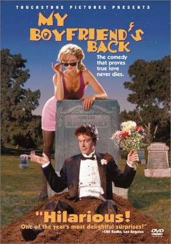 A zombie teenager in a dirt-stained tuxedo rising from his grave to hand flowers to a girl in a pink dress for the retro comedy film My Boyfriend's Back
