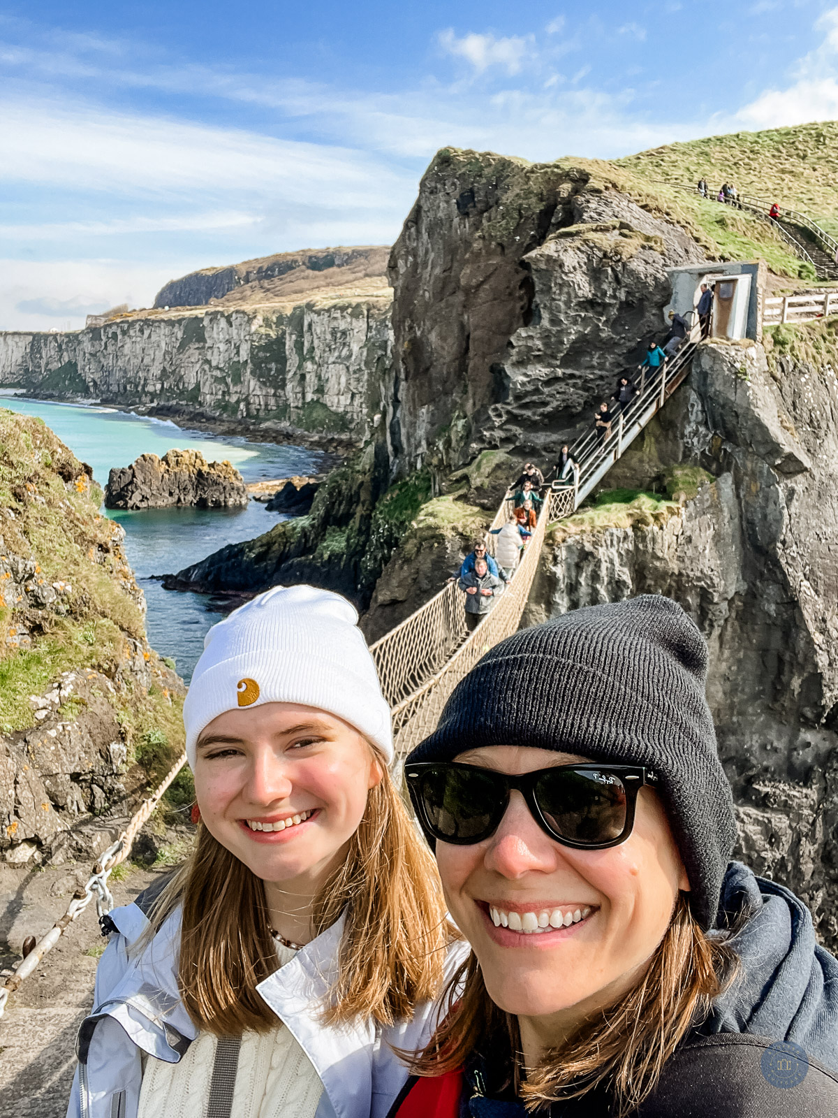 mom and daughter at carrick a rede rope bridge on causeway coast of northern ireland