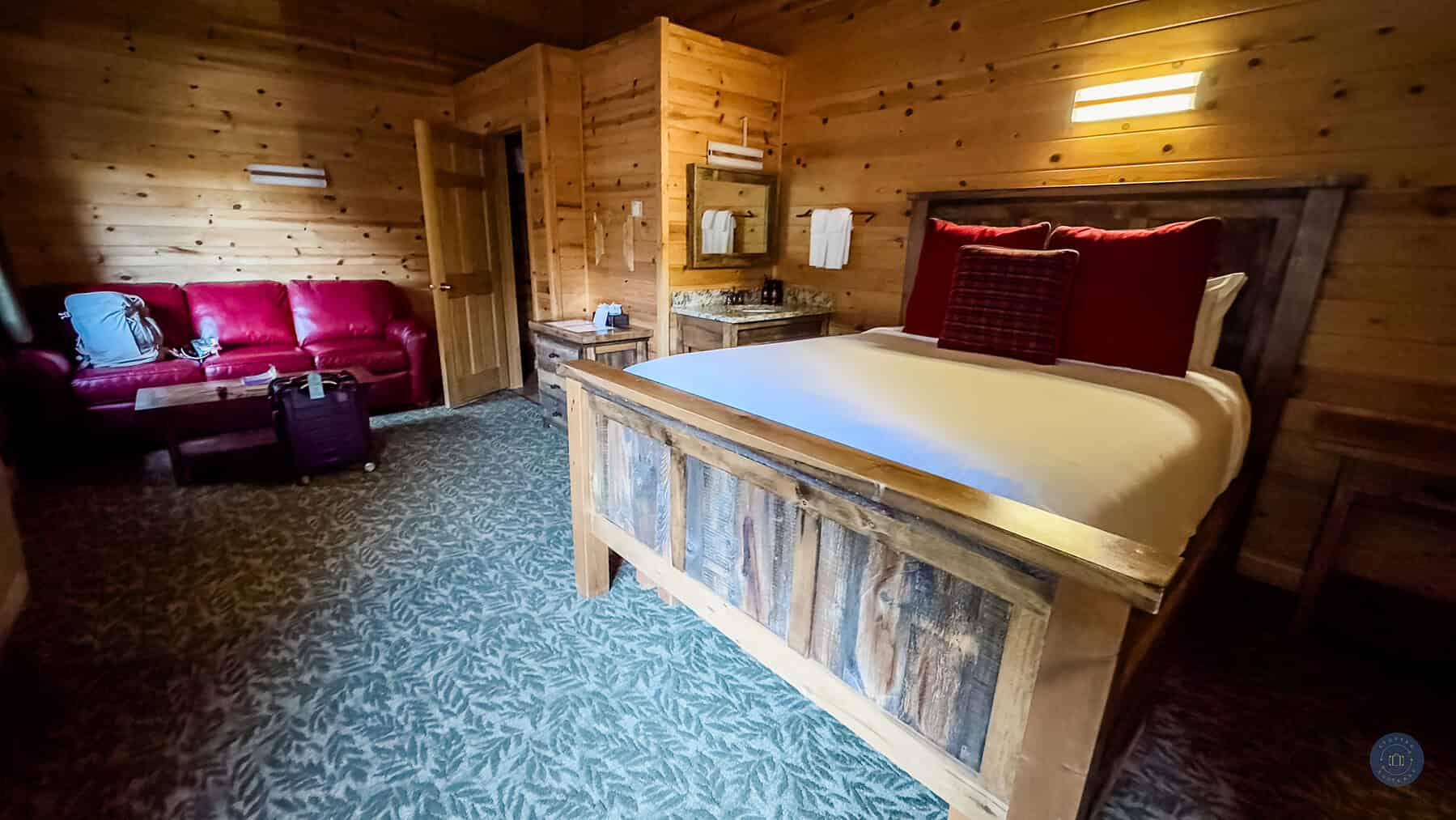 cabin room with bed, sink, couch