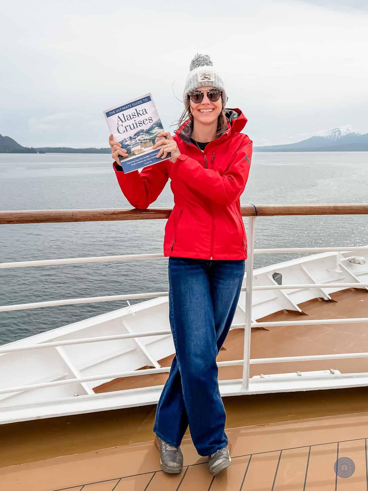 alaska cruise expert kim tate holding her guide book for alaska cruises