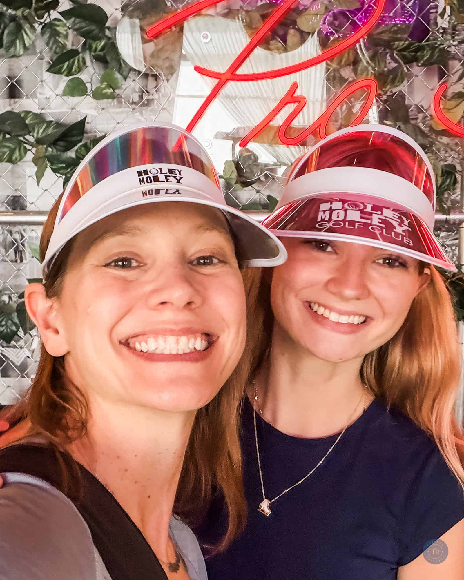 mother and daughter with holey moley visor hats on up close in irvine ca